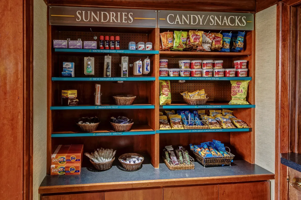 An interior view of shelves stocked with snacks and sundries, inviting guests to pick up essentials and treats. The convenience and casual setup complements longer stays and impromptu meal prep in the kitchen.